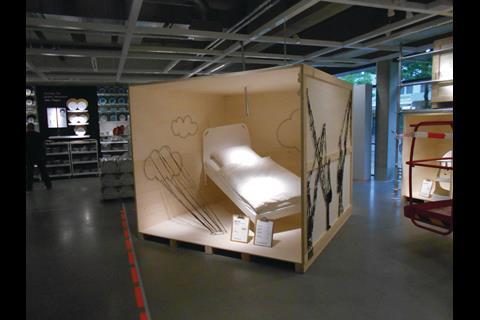 Ikea Citystore employs visual merchandising with open-sided and internally lit wooden packing crates containing items of Ikea merchandise.